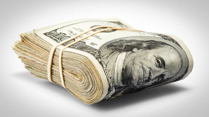 A thick folded over wad of 100 dollar bills, secured by a classy elastic band.