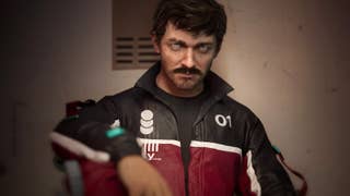 A man with a small moustache and wearying a zip-up tracksuit sat slumped against a wall and scowling at the camera. It's Jan in The Alters.