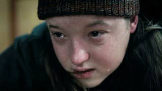 Bella Ramsey as Ellie in second season of The Last of Us. Ellie is wearing a beanie hat, has a bloody lip and is crying