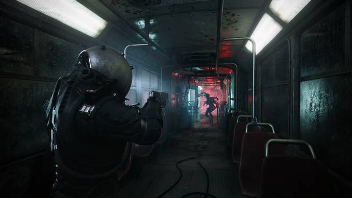 Official Cronos: The New Dawn screenshot showing you pointing your weapon down a long subway carriage towards distant silhouetted monster