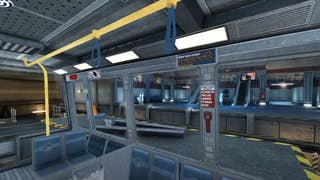 The interior of a train or tram in the opening of Half-Life 1. It's a small carriage with open sides - there are no windows - so you can see the interior of the Black Mesa research facility as Gordan Freeman travels through it. It's a mix of grey metal walls and seats and yellow posts and handrails.