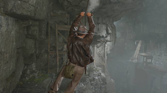 Indy uses his whip to zipline over to a new ledge in Indiana Jones and the Great Circle's Order of Giants DLC