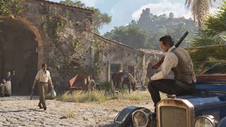 Mafia: The Old Country official promo screenshot showing a mafioso sitting on a car bonnet with shotgun over his shoulder, amongst delapidated italian buildings and rural scenery