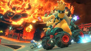 Mario Kart World official screenshot showing Bowser racing in front of a giant flaming Bowser