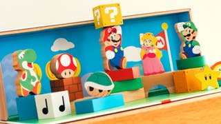 Promotional photo showing Nintendo's colourful My Mario toy block set, featuring wooden versions of Mario, Yoshi, Luigi, and Peach positioned alongside wooden question mark blocks, brick blocks, and more.